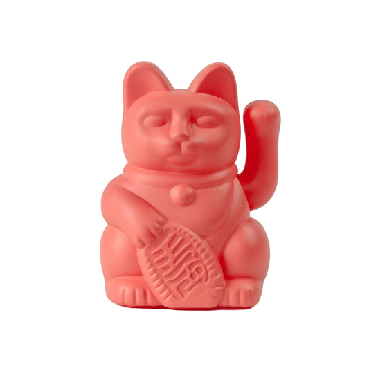 Red cat-shaped container with a paw print on a beige background