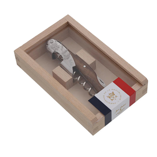 A Jean Dubost wine waiter corkscrew with a light horn and birchwood handle, presented in a wooden gift box with a French flag design on the inside lining.