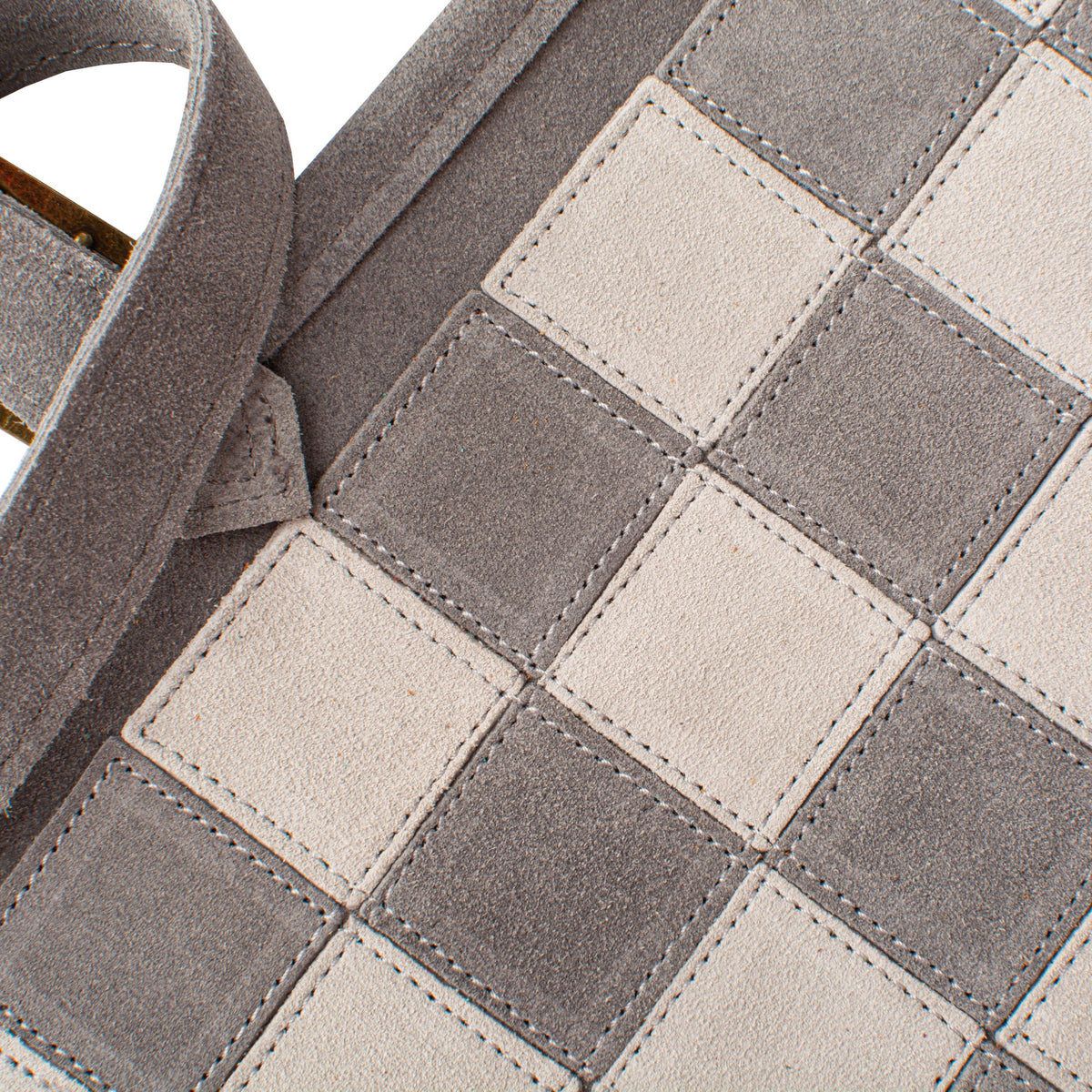 Close-up of a checkered pattern with gray and beige squares.