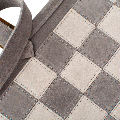 Close-up of a checkered pattern with gray and beige squares.