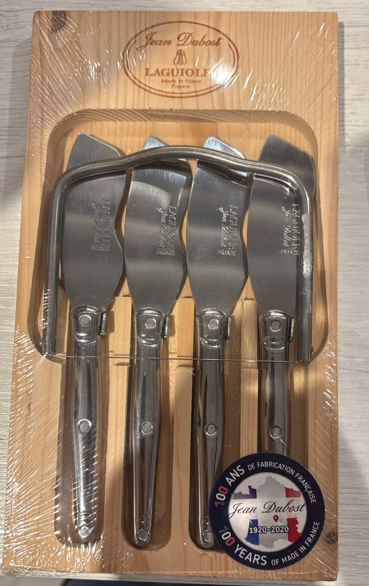 A 5-piece set of stainless steel cake and pastry spreaders in a wooden presentation box, wrapped in clear plastic. The brand 'Jean Dubost' and 'Laguiolle' are visible on the packaging.