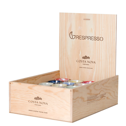 A set of multicolored espresso cups presented in an open wooden crate with the branding 'Grespresso' and 'Costa Nova'.