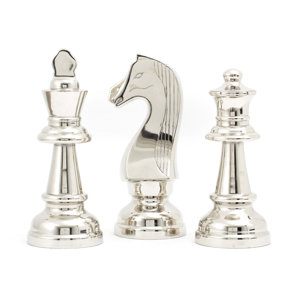 A set of three decorative chess pieces made of aluminium and nickel plated, featuring silver color. The pieces include a king, queen, and knight, standing upright on a solid surface.