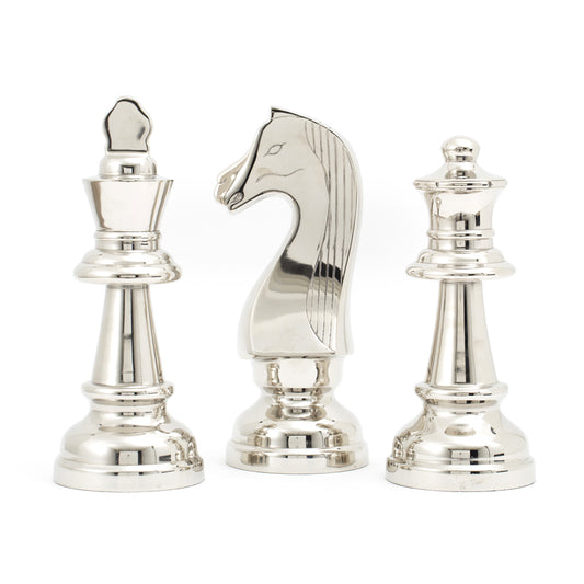 A set of three decorative chess pieces made of aluminium and nickel plated, featuring silver color. The pieces include a king, queen, and knight, standing upright on a solid surface.